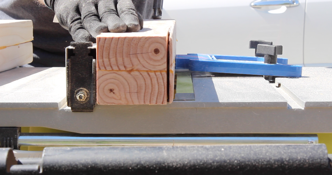 Trimming the table legs to their final width on a table saw