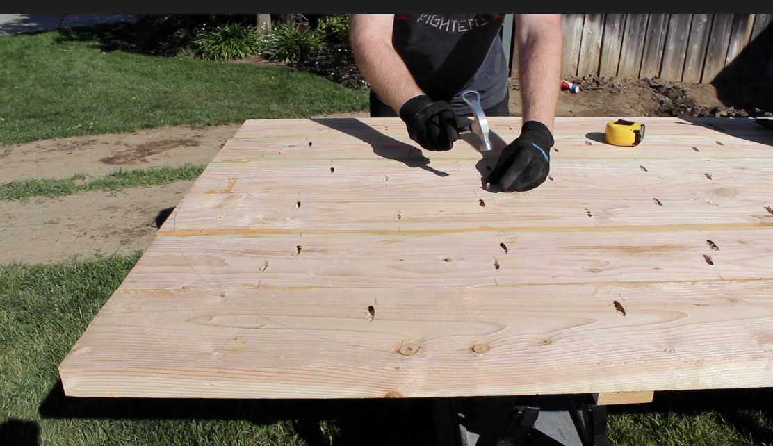 putting a nail in the bottom of the table top for the saw jig