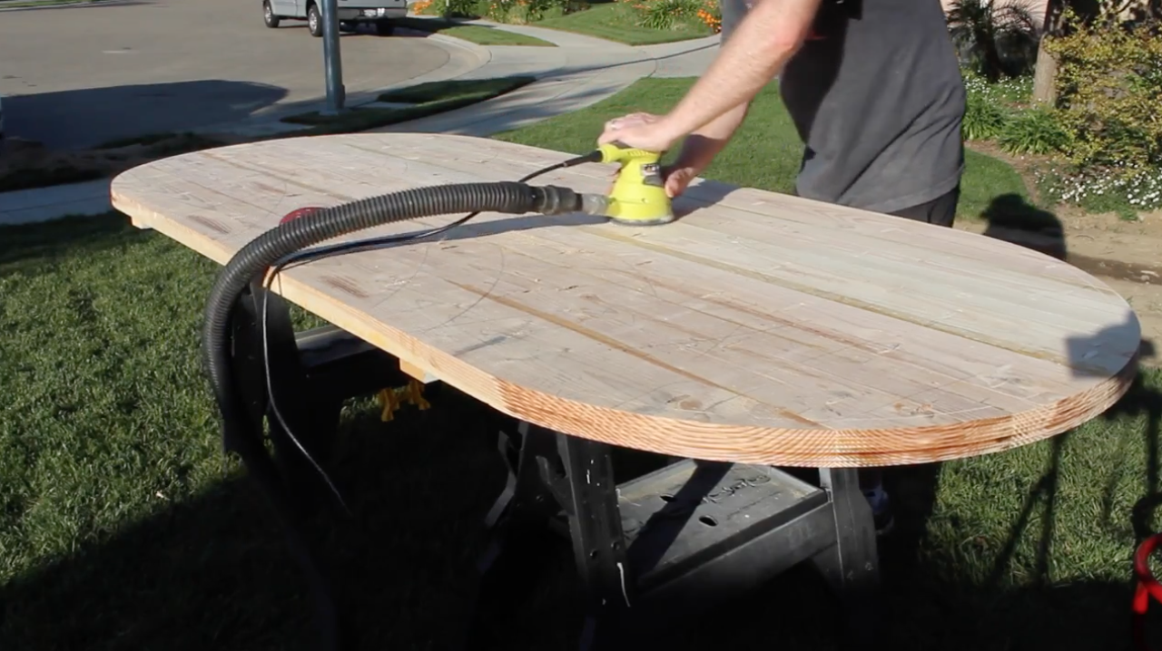Sanding the table top with a random orbital sander