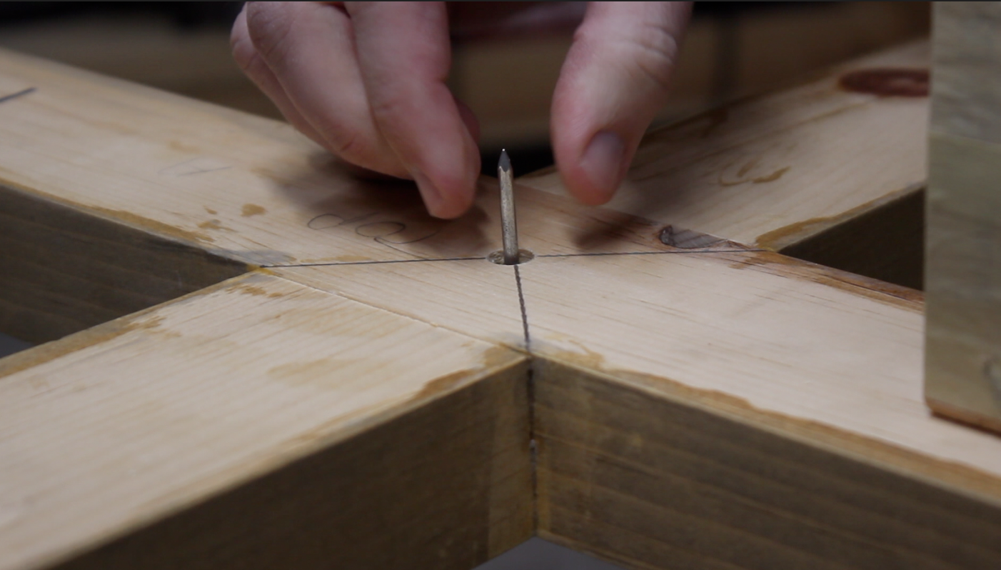 placing a nail in the top of table base to align top