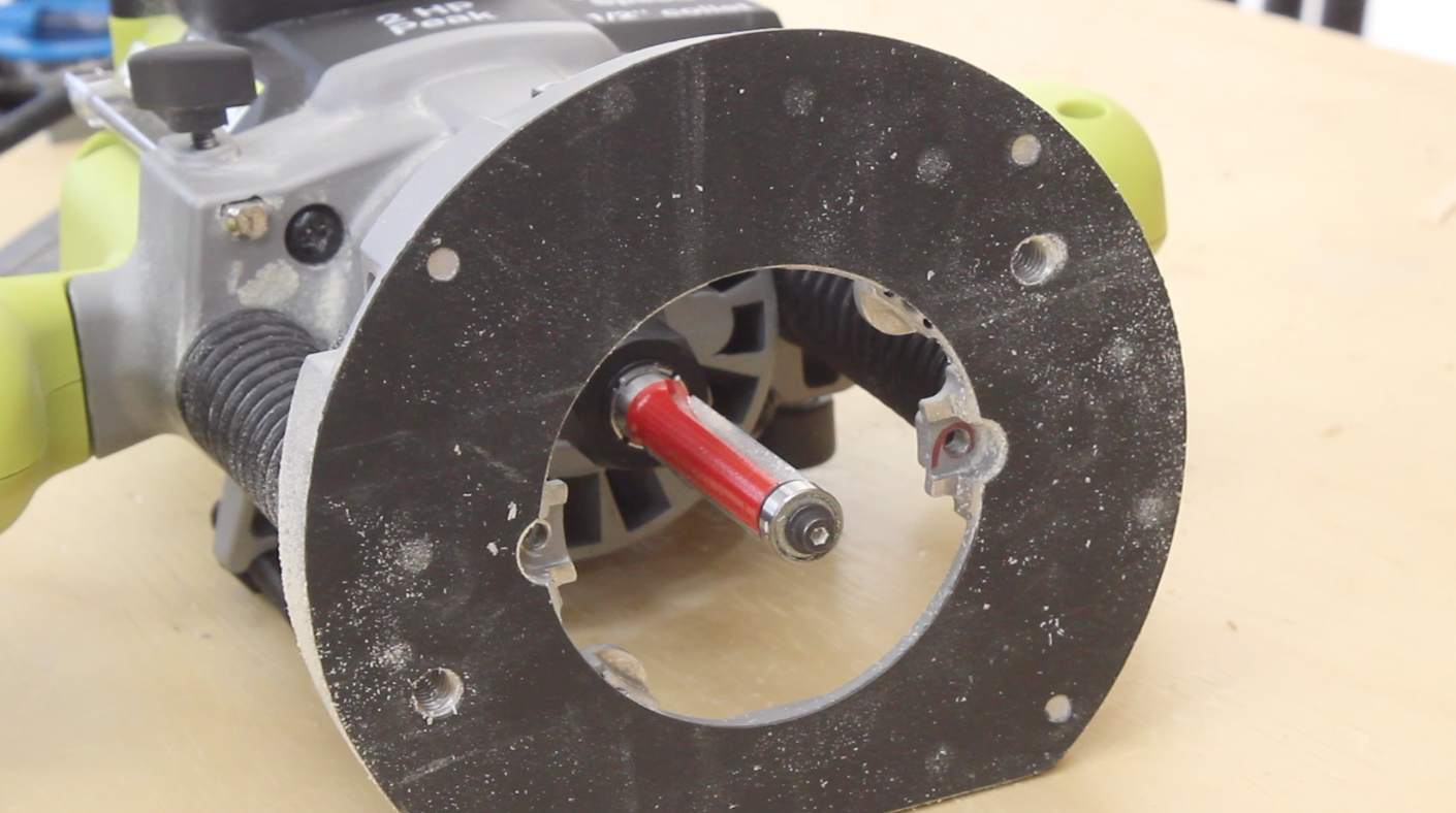 Plunge router with a flush bit sitting on a workbench