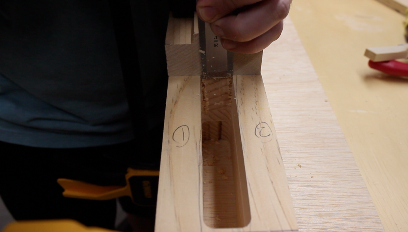 Chiseling away corners of the table leg mortises