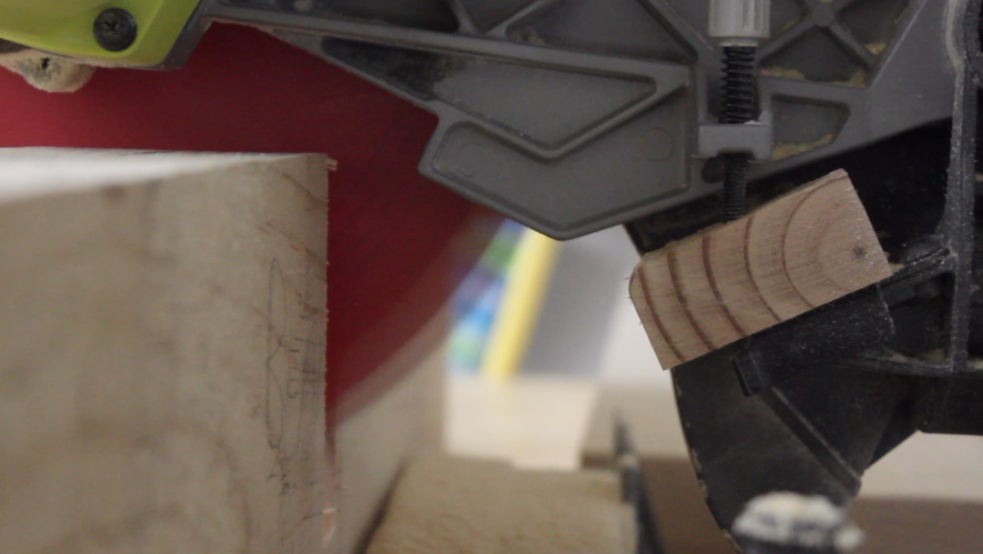 Wooden stop attached to miter saw used to cutting rabbets in bottom stretchers