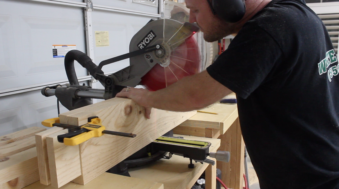 man using a miter saw to cut rabbets in table stretchers