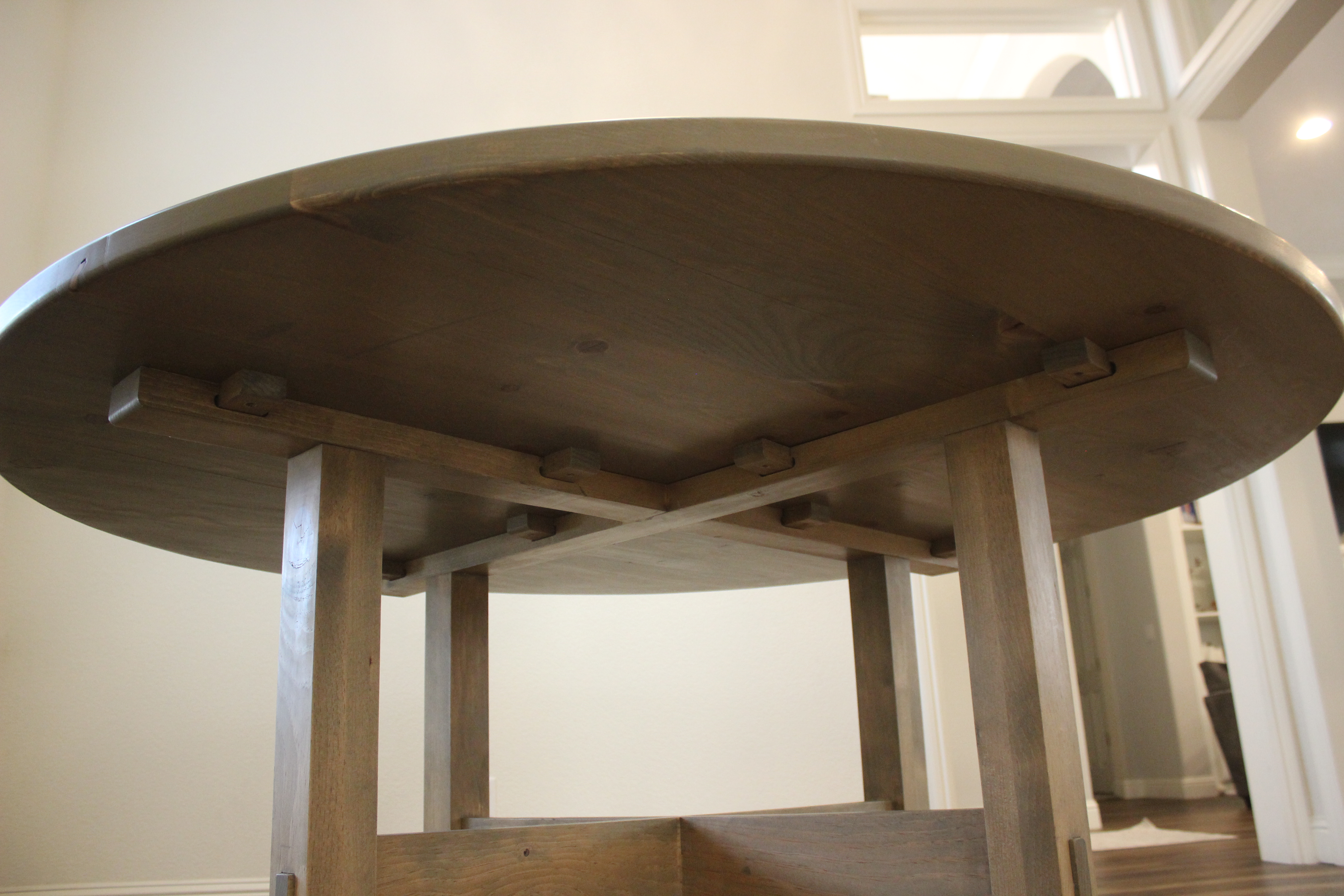 wide shot of underneath of pine dining table