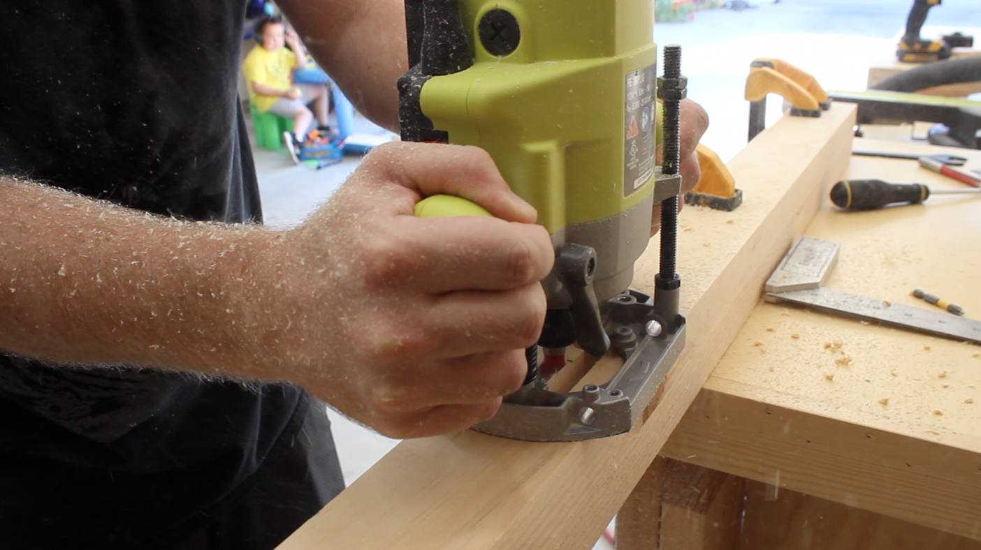 Using a plunge router to create a mortise in the table leg