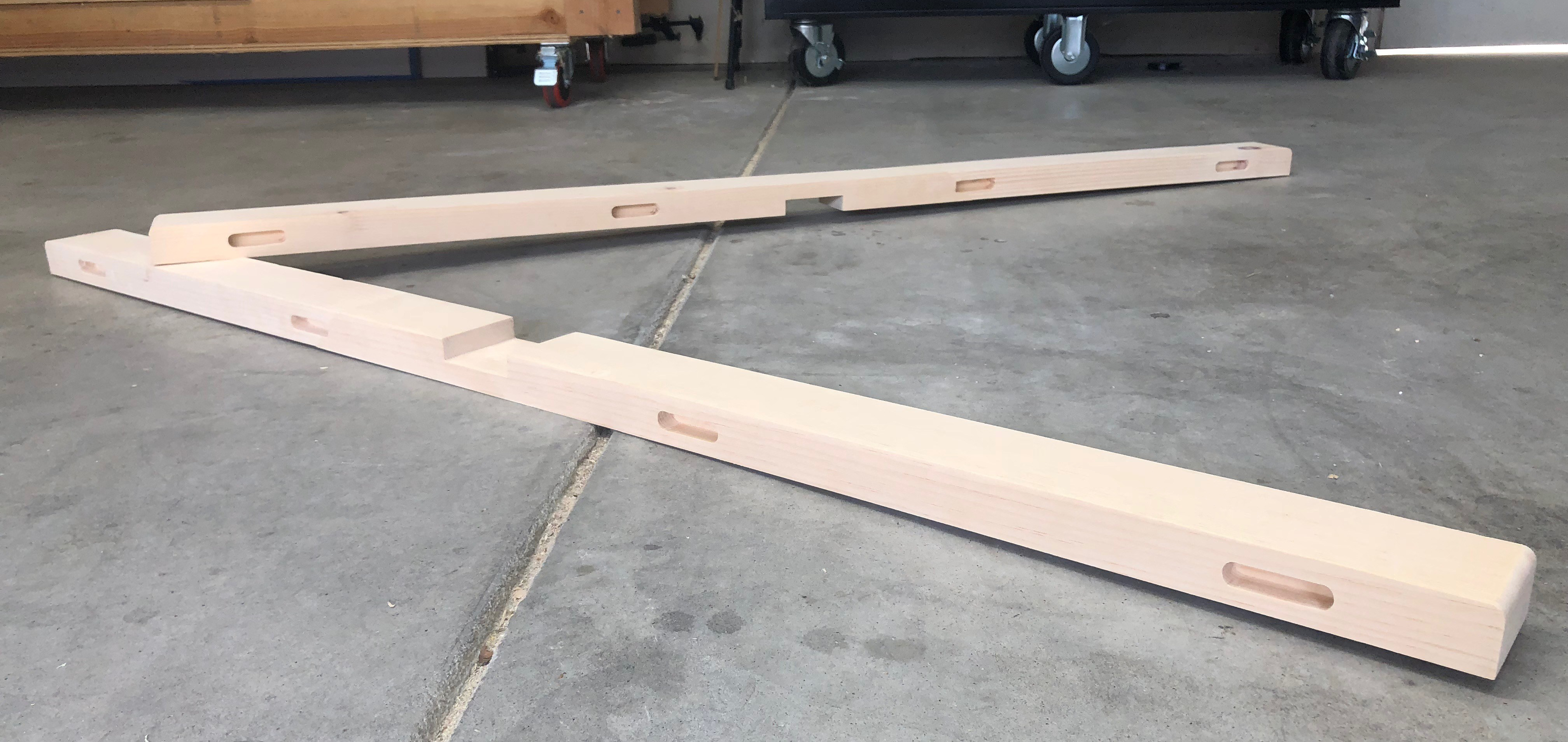 two top stretcher boards sitting on the garage floor
